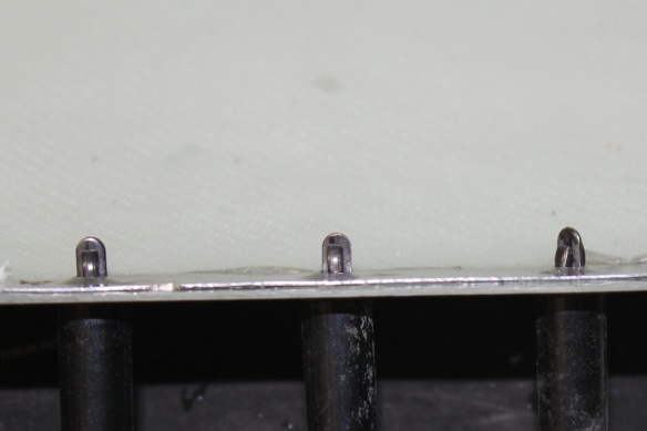 Clecos holding the bottom aluminium skin against the wingtip while it is glued into place.